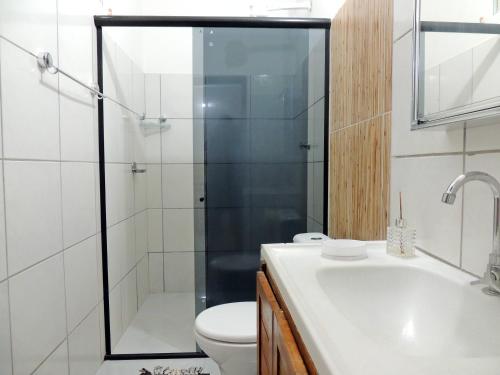a bathroom with a shower and a toilet and a sink at Nossa Casa em Jeri in Jericoacoara