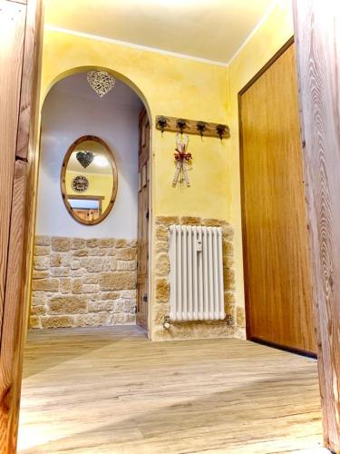 a hallway with a door and a wall with a radiator at Profumo di Legno in Valtournenche