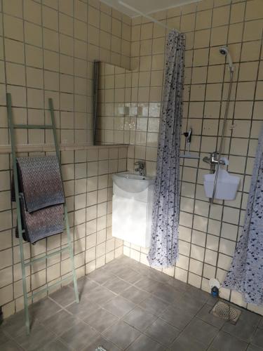 a bathroom with a shower and a sink in it at Comfortable apartment, 10min Airport in Stavanger
