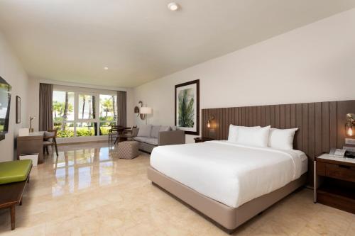 a bedroom with a large bed and a living room at Hyatt Regency Grand Reserve Puerto Rico in Rio Grande