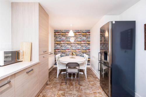 a kitchen with a table and chairs in a room at Lakeside Reach in Doncaster