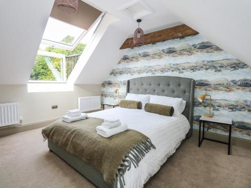 a bedroom with a large bed and a large window at The Stable at Warren House in Market Rasen