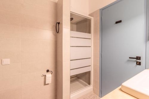 a bathroom with a shower with a glass door at Hamaretou Apartment in Sparti