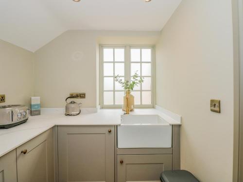 a kitchen with a sink and a window at The Hayloft at Warren House in Market Rasen