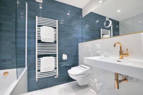 a bathroom with a toilet and a sink and a shower at Hotel Zlatá Hvězda in Litomyšl