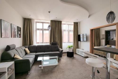 a living room with a couch and a tv at Hotel Zlatá Hvězda in Litomyšl
