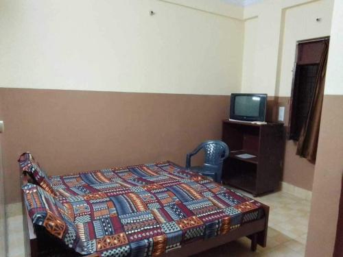 Cama o camas de una habitación en OYO Sri Radhakrishnan Guest House