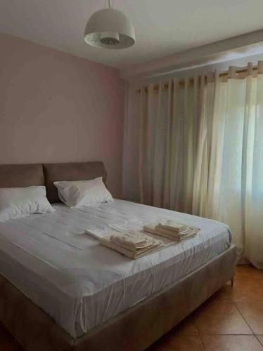 a bedroom with a bed with two towels on it at Apartment in Skanderbeg Square - Tirana Center 1 in Tirana
