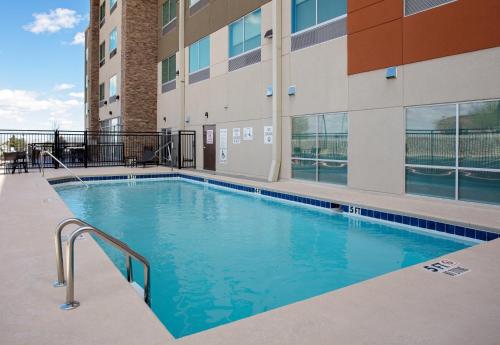 a swimming pool in front of a building at Holiday Inn Express & Suites - El Paso North, an IHG Hotel in El Paso