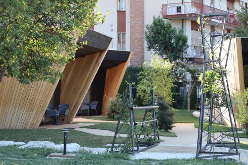 a park with a building with a wooden structure at Roggia dei Cedri in Valdobbiadene