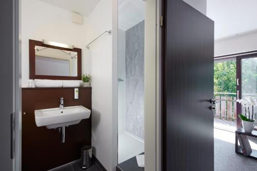 a bathroom with a sink and a mirror at Smart-Living in Winterberg