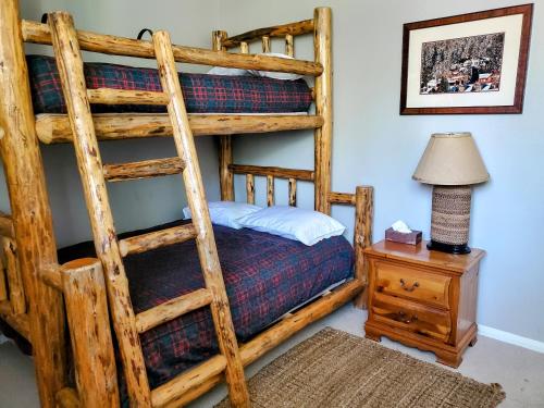 a bedroom with a bunk bed with a lamp and a table at Summit Ski Resort 2BR-2BA, Mammoth Lakes in Mammoth Lakes