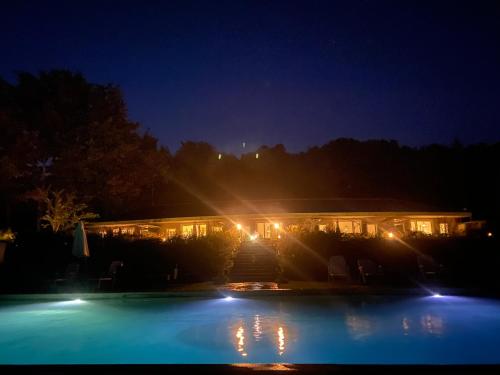 a building with a swimming pool at night at Il Mulin Vecchio in Camporgiano