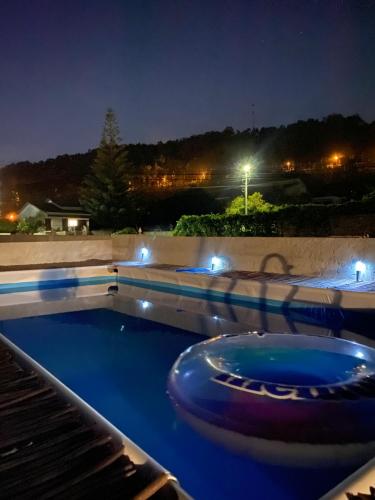 una grande piscina notturna con luci di Casa Vista Mar a Castelo do Neiva