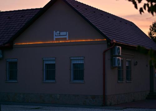 a house with a sign on the side of it at R.Gold Apartman in Makó