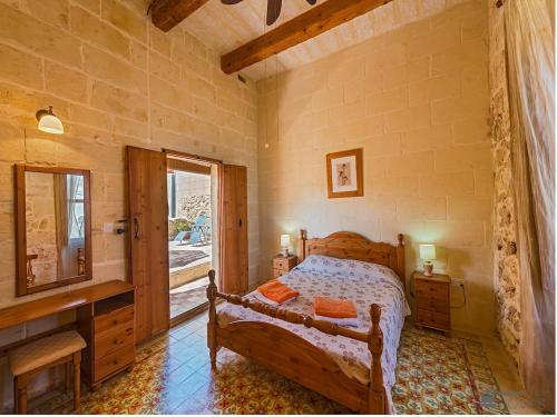a bedroom with a bed and a television and a window at Lellux Holiday Home in Nadur