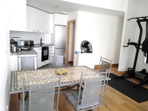 a kitchen with a table and chairs in a room at RiverSide in Barakaldo
