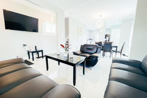 a living room with a couch and a table at The Ashland Manor in Niagara Falls