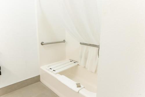 a white bathroom with a tub and a towel rack at Country Inn & Suites by Radisson, Helen, GA in Helen