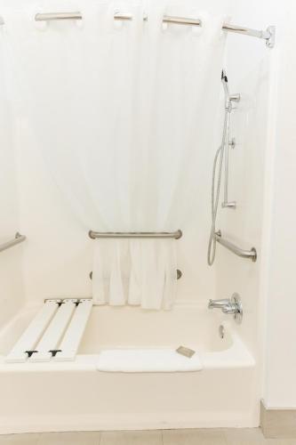 a white bathroom with a tub and a shower at Country Inn & Suites by Radisson, Helen, GA in Helen