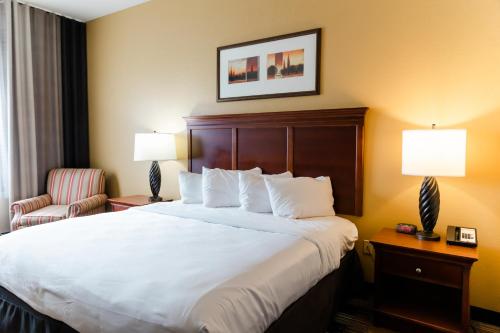 a hotel room with a large bed and a chair at Country Inn & Suites by Radisson, Helen, GA in Helen