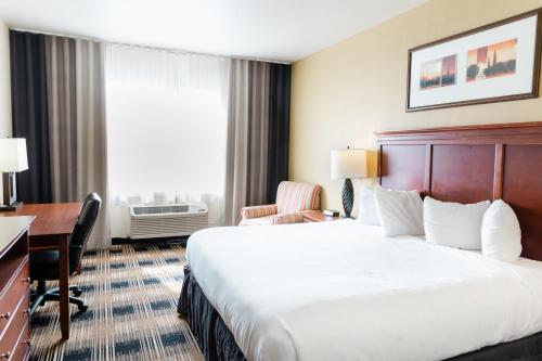 a hotel room with a large bed and a desk at Country Inn & Suites by Radisson, Helen, GA in Helen