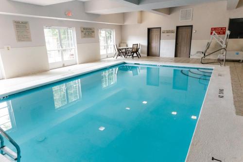 a large pool with blue water in a building at Country Inn & Suites by Radisson, Helen, GA in Helen