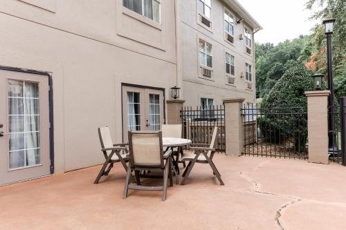 a patio with a table and chairs in front of a building at Country Inn & Suites by Radisson, Helen, GA in Helen