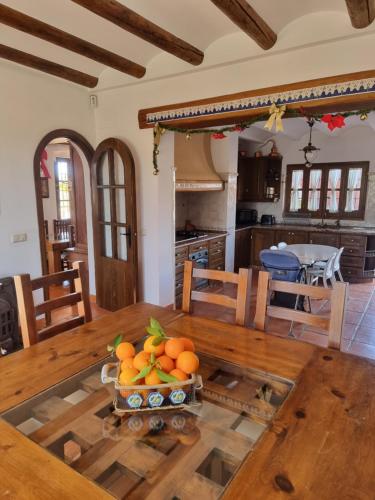una cocina con una mesa con un tazón de naranjas. en Finca exclusiva (10.000m2) para 10-17 personas, en Sevilla