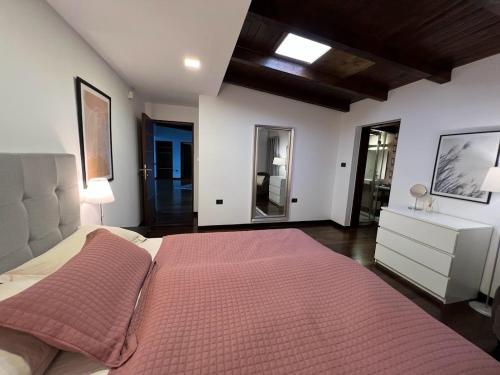 a bedroom with a large bed with a red blanket at Villa Hanan Sarajevo in Sarajevo