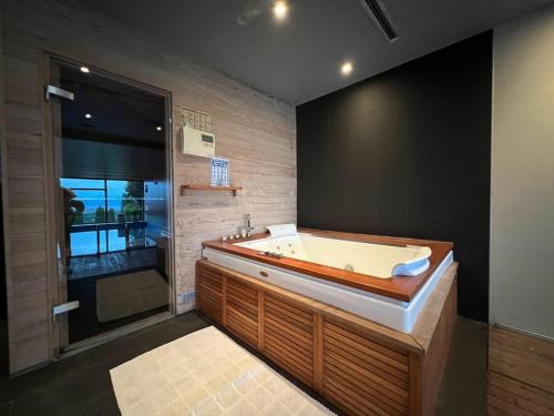 a large bathroom with a tub and a window at Villa Hanan Sarajevo in Sarajevo