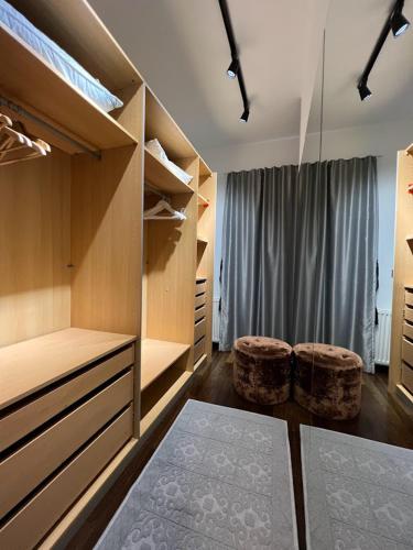 a closet with two ottomans and two stools at Villa Hanan Sarajevo in Sarajevo