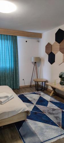 a room with a bed and a rug on the floor at Motel "KULA" in Cazin