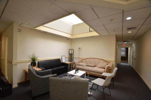 a living room with a couch and a table and chairs at Michie House in College Hill in Providence