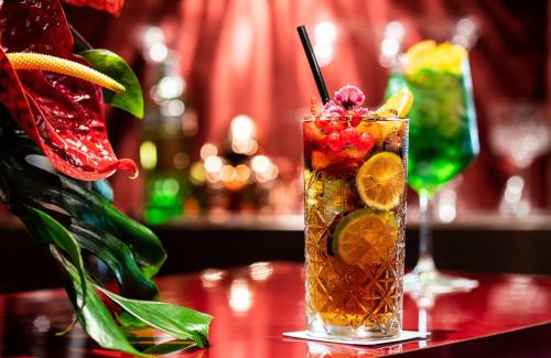 a drink with fruit on a table in a bar at Leonardo Royal Hotel Venice Mestre in Mestre