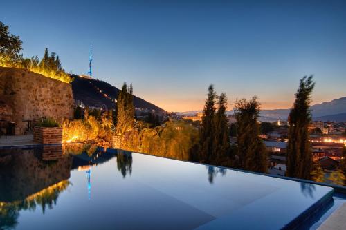 a swimming pool with a view of a city at Castle in Old Town in Tbilisi City