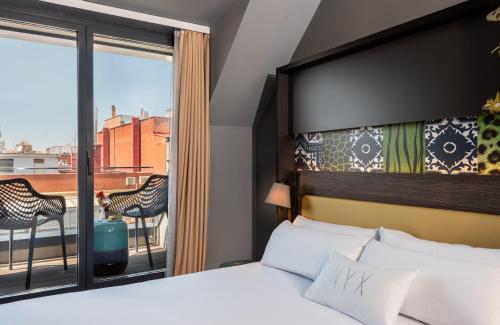 Ένα ή περισσότερα κρεβάτια σε δωμάτιο στο NYX Hotel Madrid by Leonardo Hotels