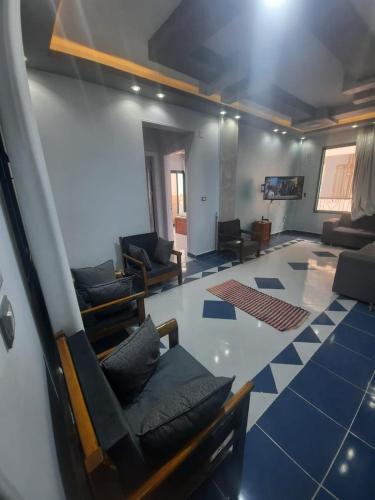 a living room with couches and chairs in a room at الغردقة، منطقة عرابية in Hurghada
