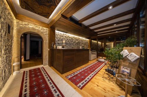 a living room with a counter and a rug on the floor at Hotel - Kulla e Zenel Beut in Peje