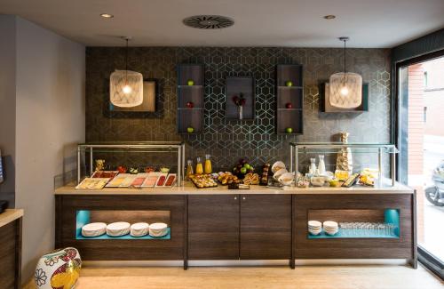 a bakery with a counter with food on it at Leonardo Boutique Hotel Madrid in Madrid