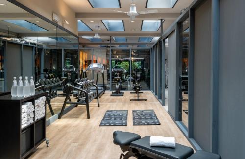 a gym with a lot of treadmills and ellipticals at NYX Hotel Milan by Leonardo Hotels in Milan