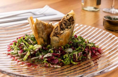 a plate of food with a salad on a table at Leonardo Hotel Bad Kreuznach in Bad Kreuznach