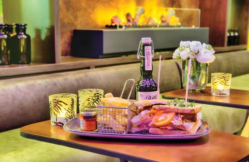 a sandwich on a plate on a table at Leonardo Royal Hotel Ulm in Ulm