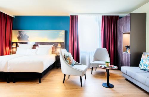 ein Hotelzimmer mit einem Bett und einem Sofa in der Unterkunft NYX Hotel Mannheim by Leonardo Hotels in Mannheim