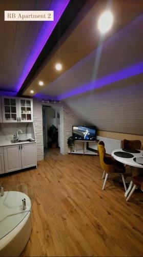 a living room with purple lights on the ceiling at RB Apartment 1 (SPA) & 2 in Palić
