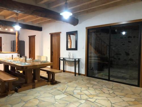a dining room with a table and a glass shower at le Pargagnat in Préchac