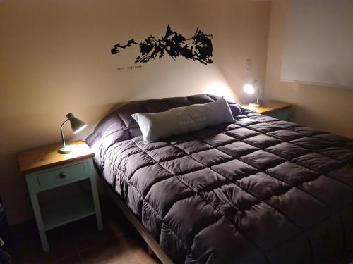 Gulta vai gultas numurā naktsmītnē Suite Vintage Bariloche