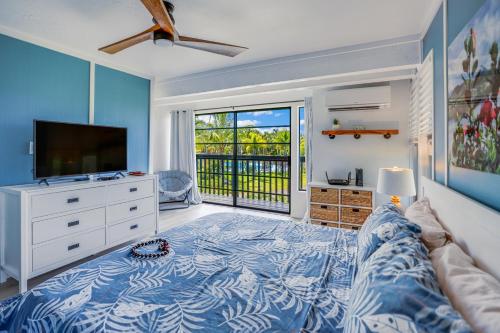 a living room with a bed and a television at View House Tower! in Princeville