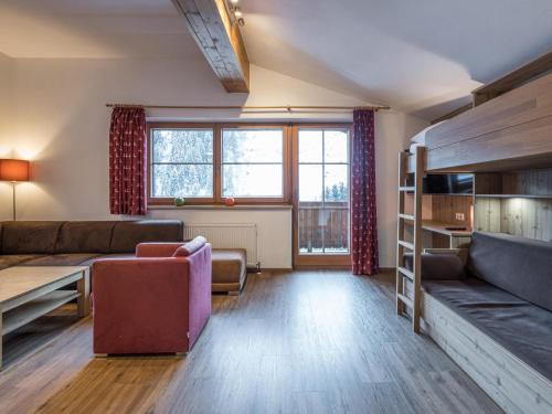 a living room with a couch and a bunk bed at Alpensteinbock Saalbach C in Saalbach-Hinterglemm