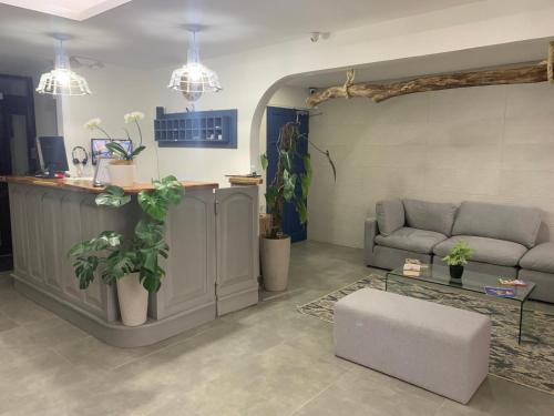 a living room with a couch and a table at Berlor Airport Inn in Alajuela City